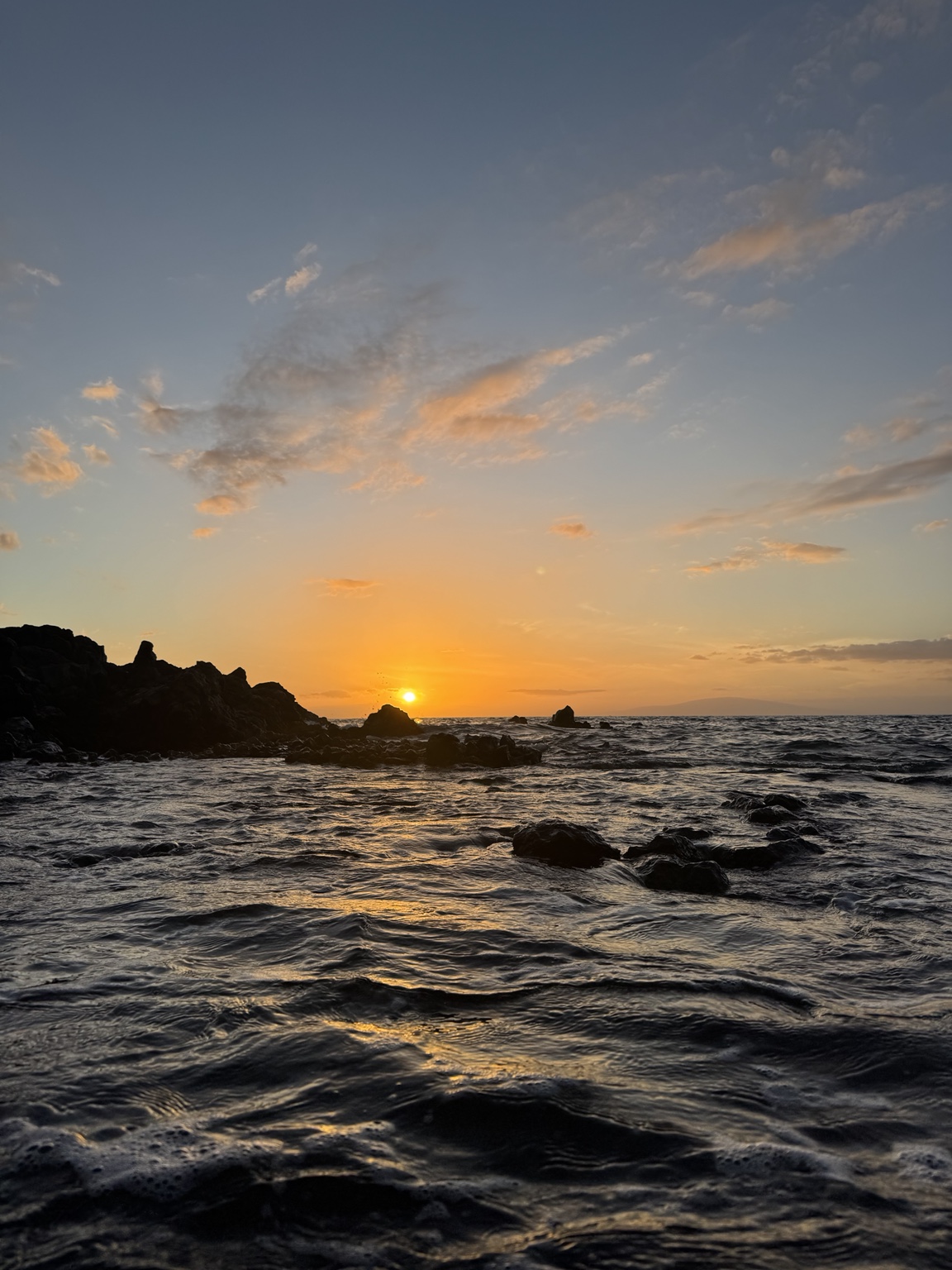 Sunset over a rocky coastline