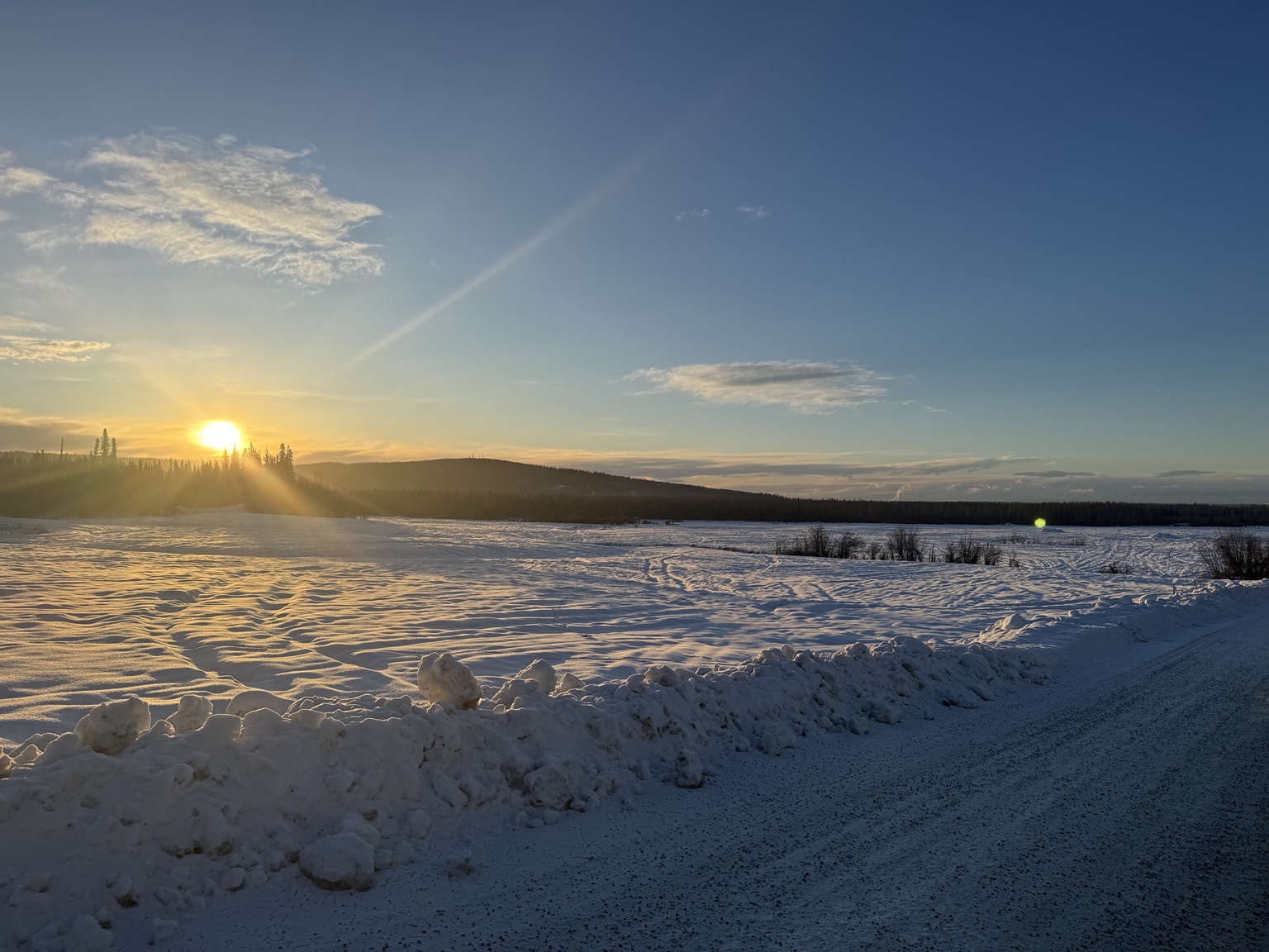 Low sunlight over a snowy landscape